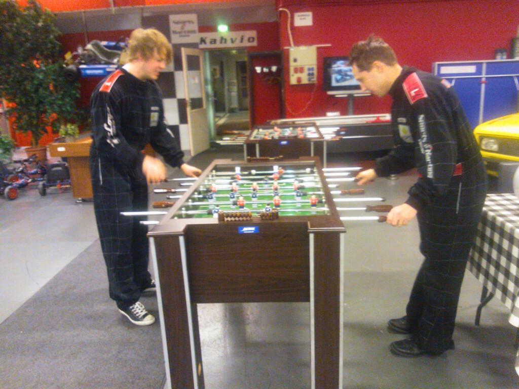 Old photo where Mikael Komu and Lasse Määttä are playing foosball.